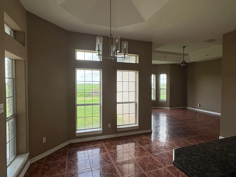 Comfortable dining area right off the kitchen _ ideal for family meals or entertaining guests with easy access to the backyard.