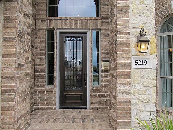 Open and inviting entry with Mahogany and wrought Iron  Front door!