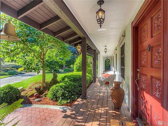 Long covered front porch & brick paved walkway.