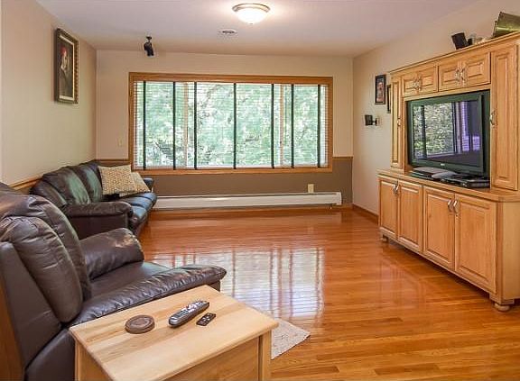 A closer look at the living area and hardwood floors. The custom entertainment center is built-in, i