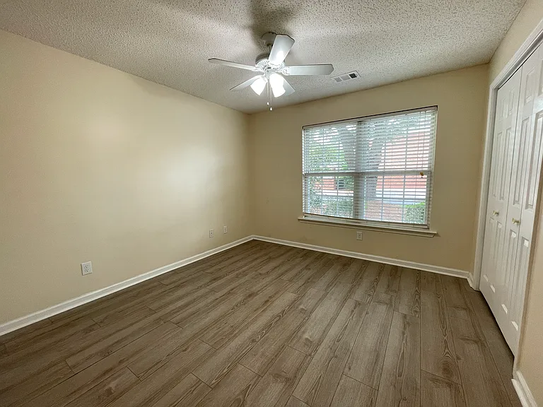 Spacious second bedroom with attached closet and ample natural light