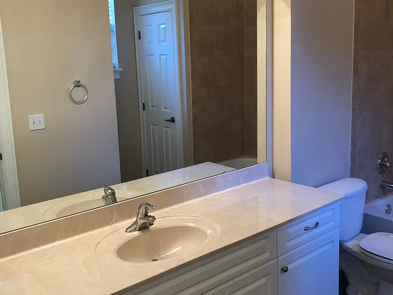 Large full bath with a window for natural light.