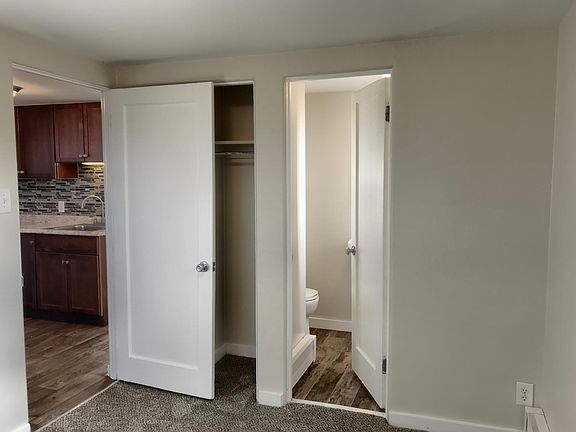 Bedroom looking into closet and bathroom.