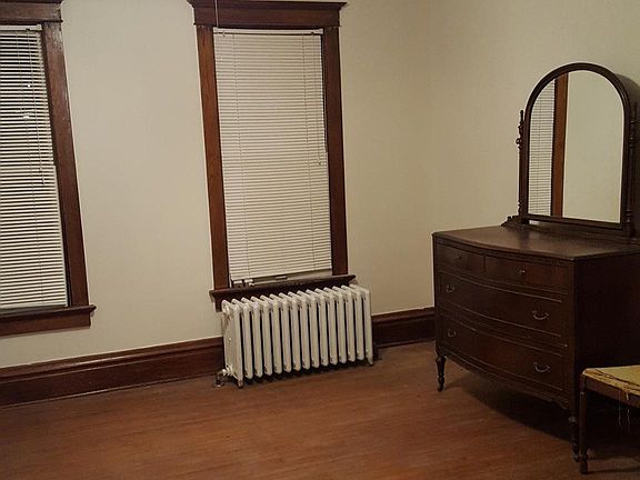 Bedroom - wood floors, original wood trim, ceiling fan.