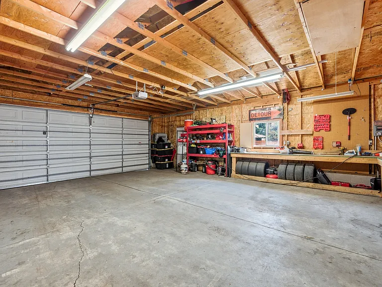 Huge 4 car garage with work bench accessible from the back alley. Additional walkway to the home from here.