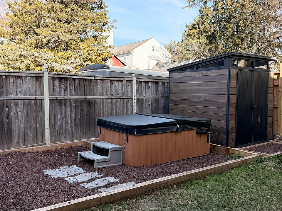 Private fenced in backyard with shed, grill and hot tub.
