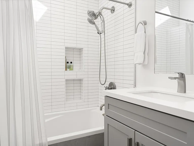 Tiled shower with built-in niche and contemporary fixtures.