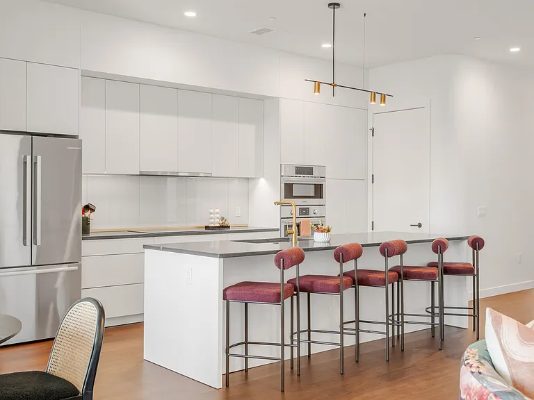 Bright white kitchen with modern conveniences and a large pantry