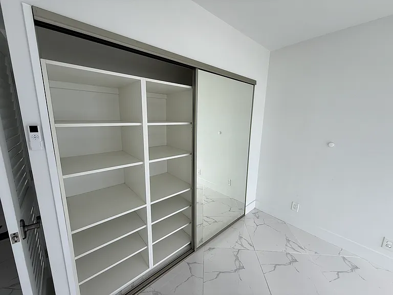 GUEST BEDROOM or OFFICE with dimmable designer lighting, full wall mirror, floor-to-ceiling impact windows, electric blackout curtain, zebra shades & large closet system