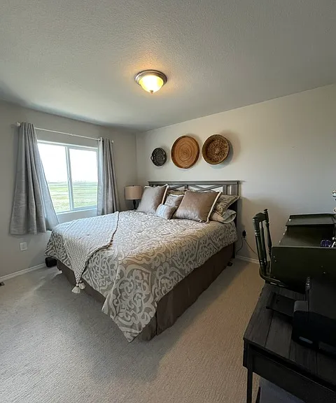 Bedroom 3 with king bed and large window with views