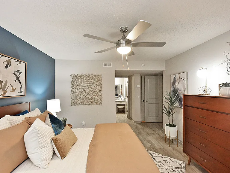 Bedroom with hardwood-style flooring and ceiling fan