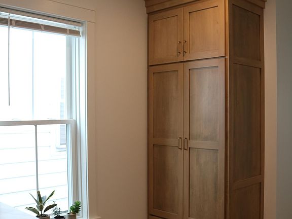 storage closet with coat rack, bar countertop
