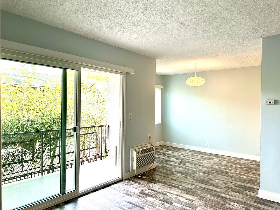 Living, Dining and Balcony with A/C unit.