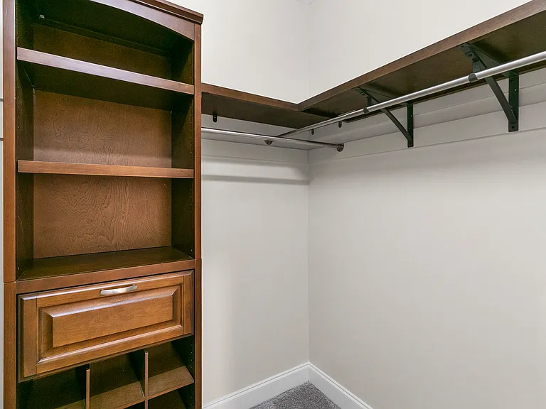 Primary bedroom walk-in closet with organizer