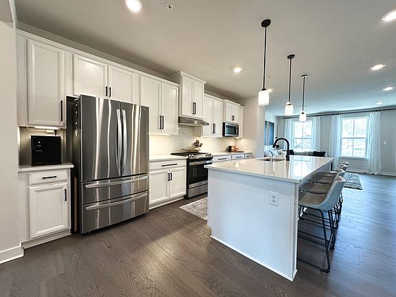 Main Level - Kitchen (Lots of Cabinetry, Stainless Steel Appliances, Oversized Quartz Island, Touch Faucet, Black Accents)