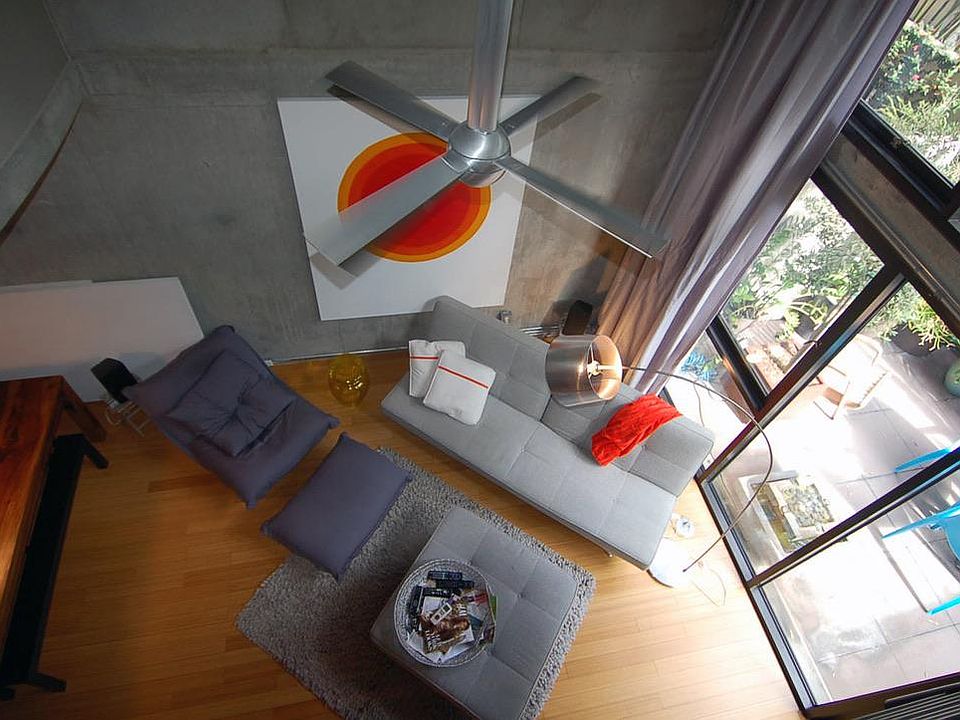 17.7 foot ceilings with exposed concrete. Aluminum ceiling fan with long down rod
