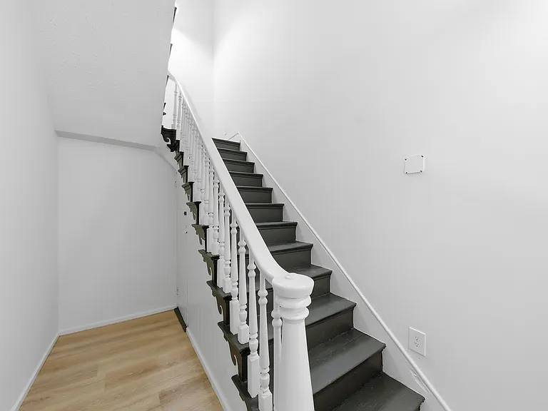 Stairs up to apartment, which is on 2nd and third floors.

On the left, there's a door (hard to see) down to the basement, where there is free laundry, which is shared with the other unit.