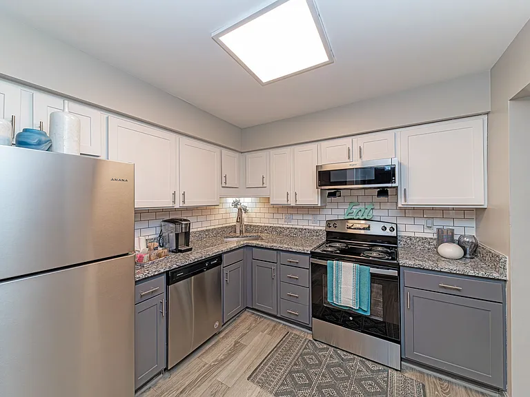 Kitchen with granite counters and two-tone modern cabinetry