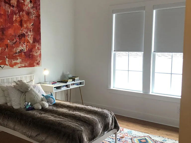 Bedroom 2 with vaulted ceiling and fan.