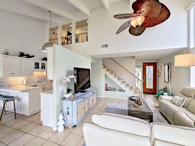 View towards front door, stairs and kitchen.