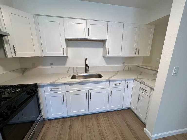 Kitchen with newly installed cabinets, countertop and sink!