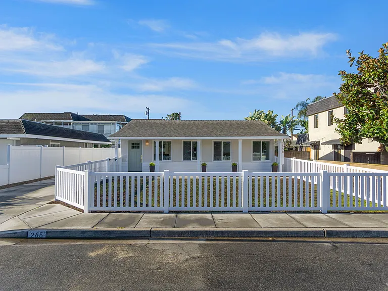 Large enclosed front yard with fresh grass