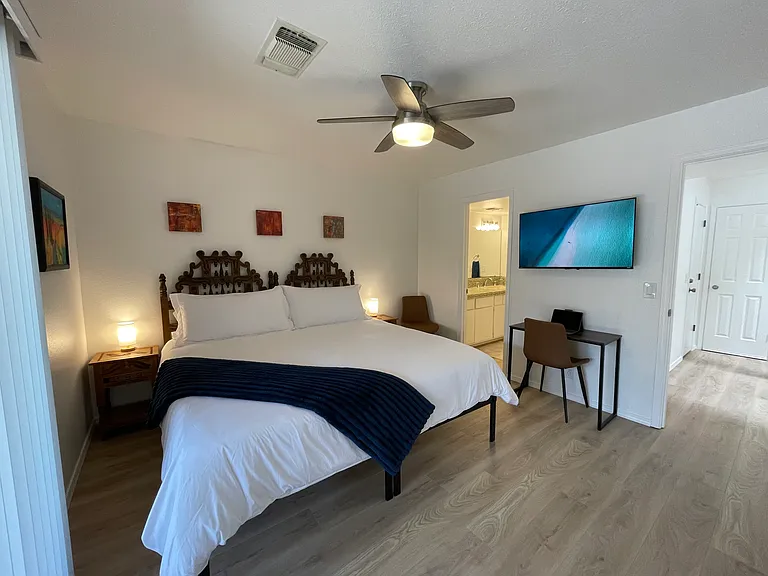 Secondary Bedroom in king bed configuration with dedicated work area, Roku TV, ensuite bathroom