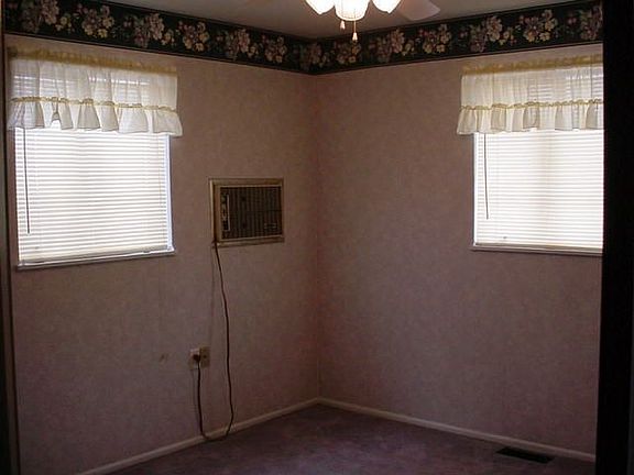 Main Bedrm w/ window A/C and ceiling fan
