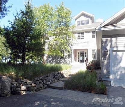 Handsome entry to home from guest parking area is attractively screened from road side view both by natural terrain & native trees.