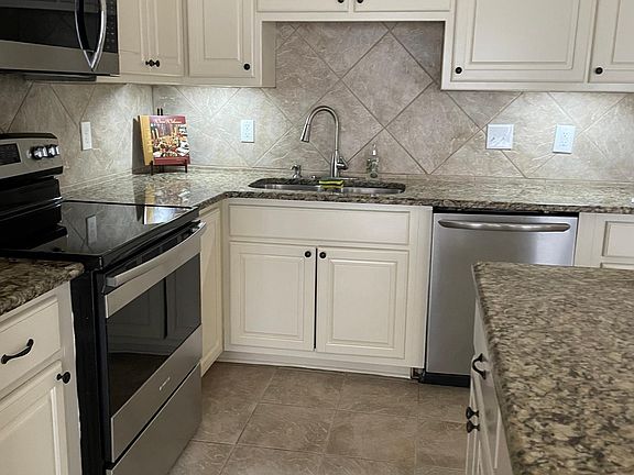 Kitchen with stainless steel appliances -new refrigerator and new stove.