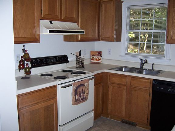 New vinly floors in kitchen with tons of cabinets and a window over the sink!