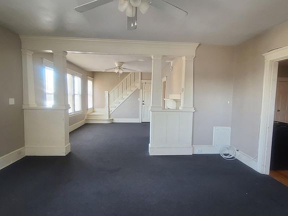 Double living room with stairway leading to bedroom 3