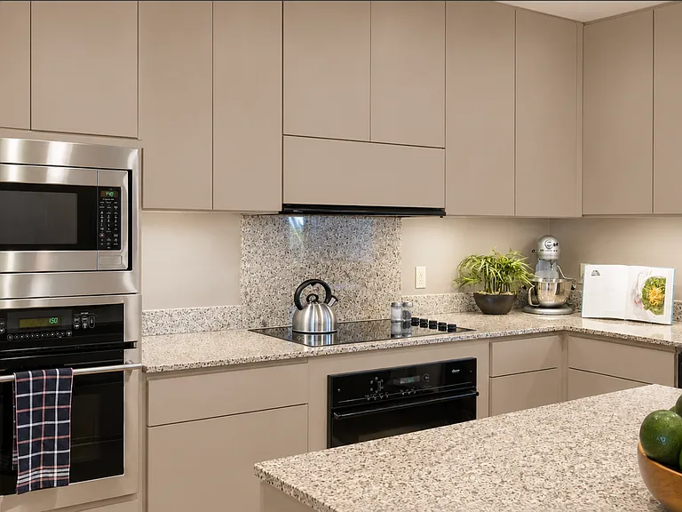 Bright functional kitchen with abundant cabinetry, generous counter space, and a large center island. Designed for everyday living and entertaining, it flows seamlessly into the dining and living areas while capturing the home's warm, inviting atmosphere.