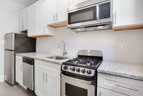 Renovated kitchen with granite countertops and stainless steel appliances - President Madison