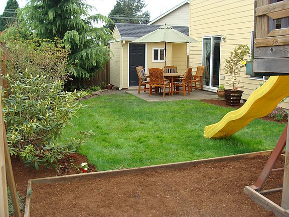 Backyard with play structure, shed