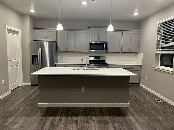 Kitchen with Stainless Steel appliances and large quartz countertop