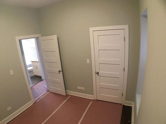 unfurnished view of bedroom #1 (with floor protectors during construction)