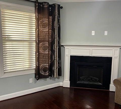 Living room with hardwood floors and a electric fireplace