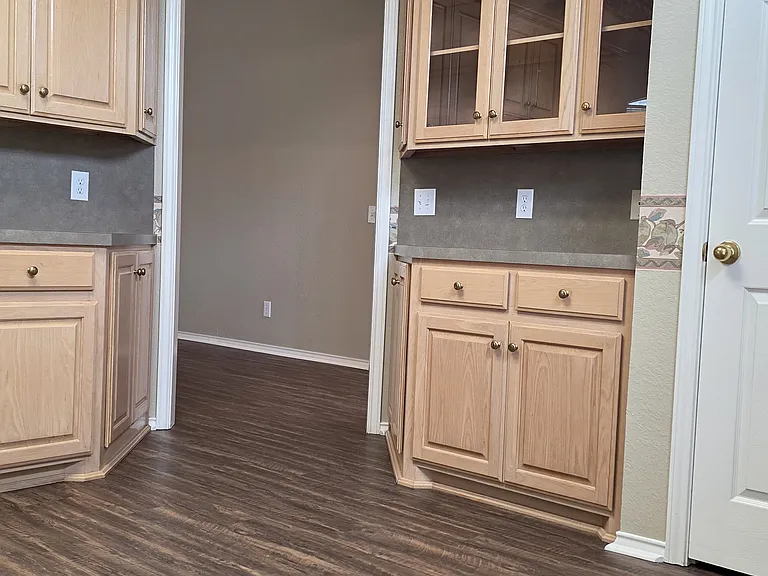 STANDING IN FROM OF WINDOW LOOKING THROUGH TO FAMILY ROOM