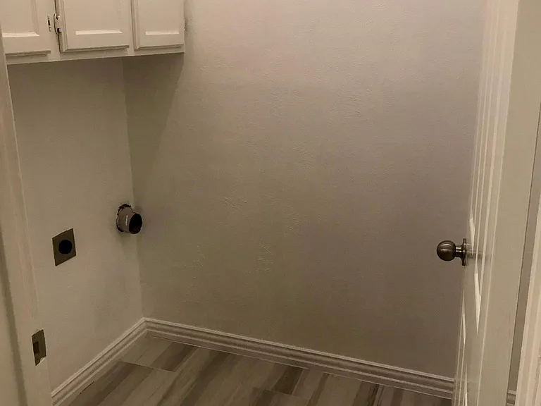 full size washer/dryer hookups with large, built in cabinets above for extra storage