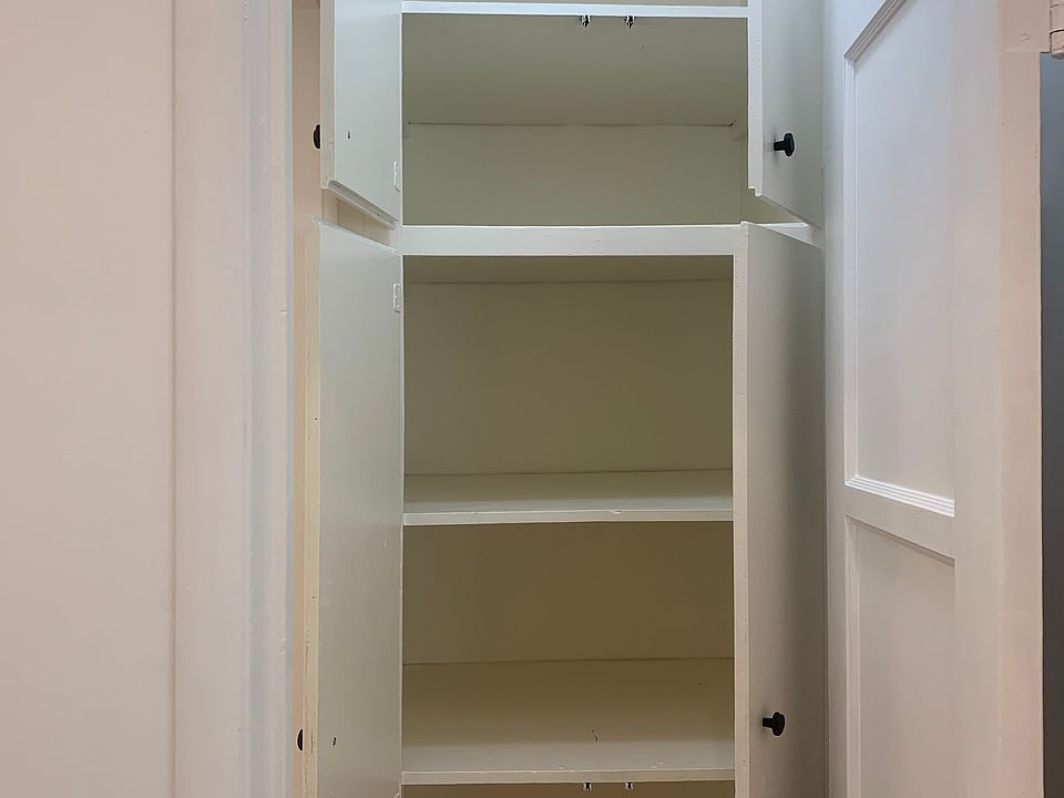 Closet leading to bathroom. Lots of deep storage.