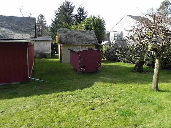 Two storage sheds located behind the garage.
