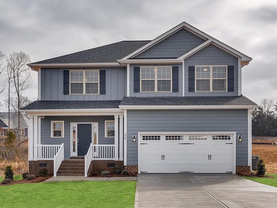 Beautiful blue home with great curb appeal. * Color was added to this pic in the grass that's currently a more dormant yellow shade but will green up this spring!