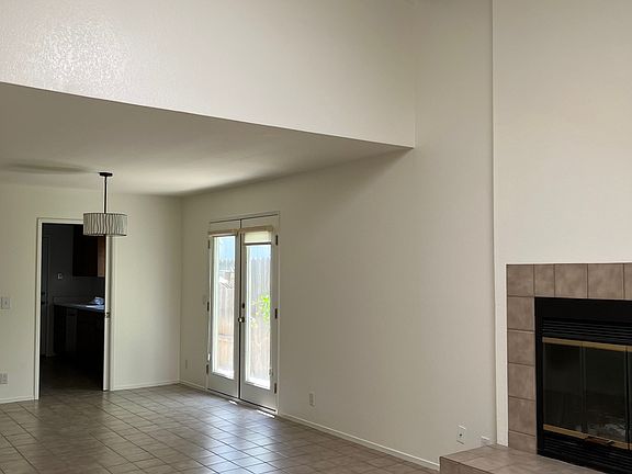 Main room looking toward kitchen and lofted primary bedroom