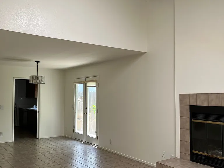 Main room looking toward kitchen and lofted primary bedroom