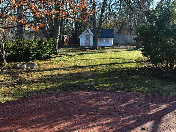 Backyard overlooking a brick patio