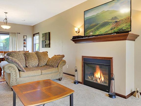 The family room has a fireplace with gas logs, oil rubbed bronze sconces and ceiling fan.  Ceilings are 9 feet in the main level of this town home.
