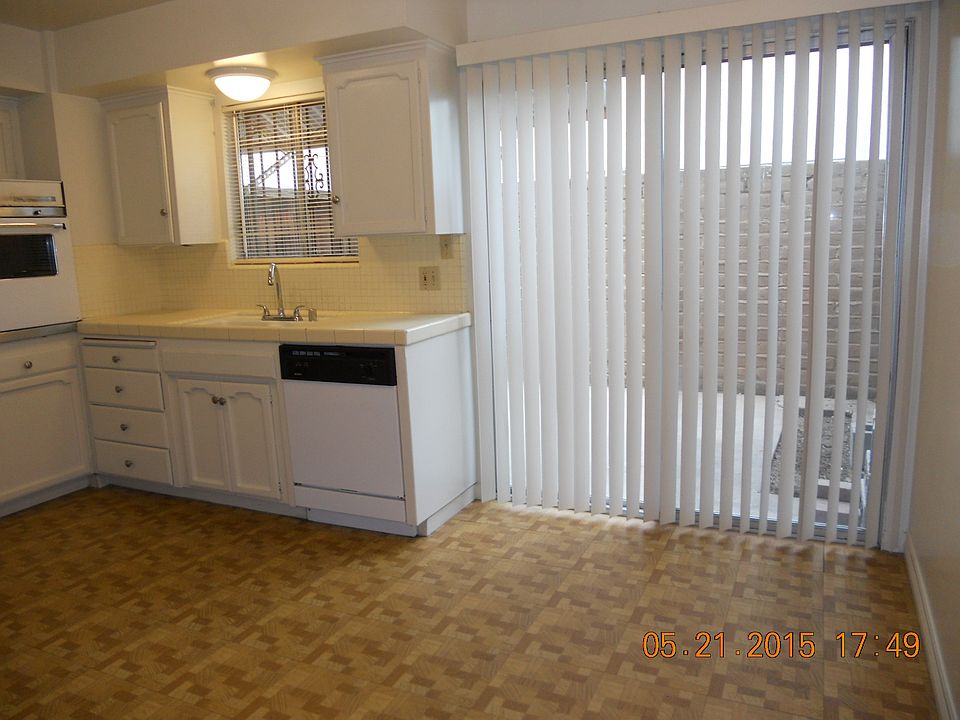 Kitchen dishwasher and doorway to Patio.