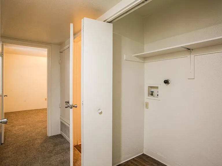 Laundry closet with washer and dryer hookups