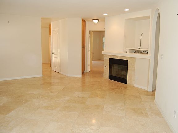Travertine Flooring, Fireplace, Media Niche, Recessed Lighting in Living Room!